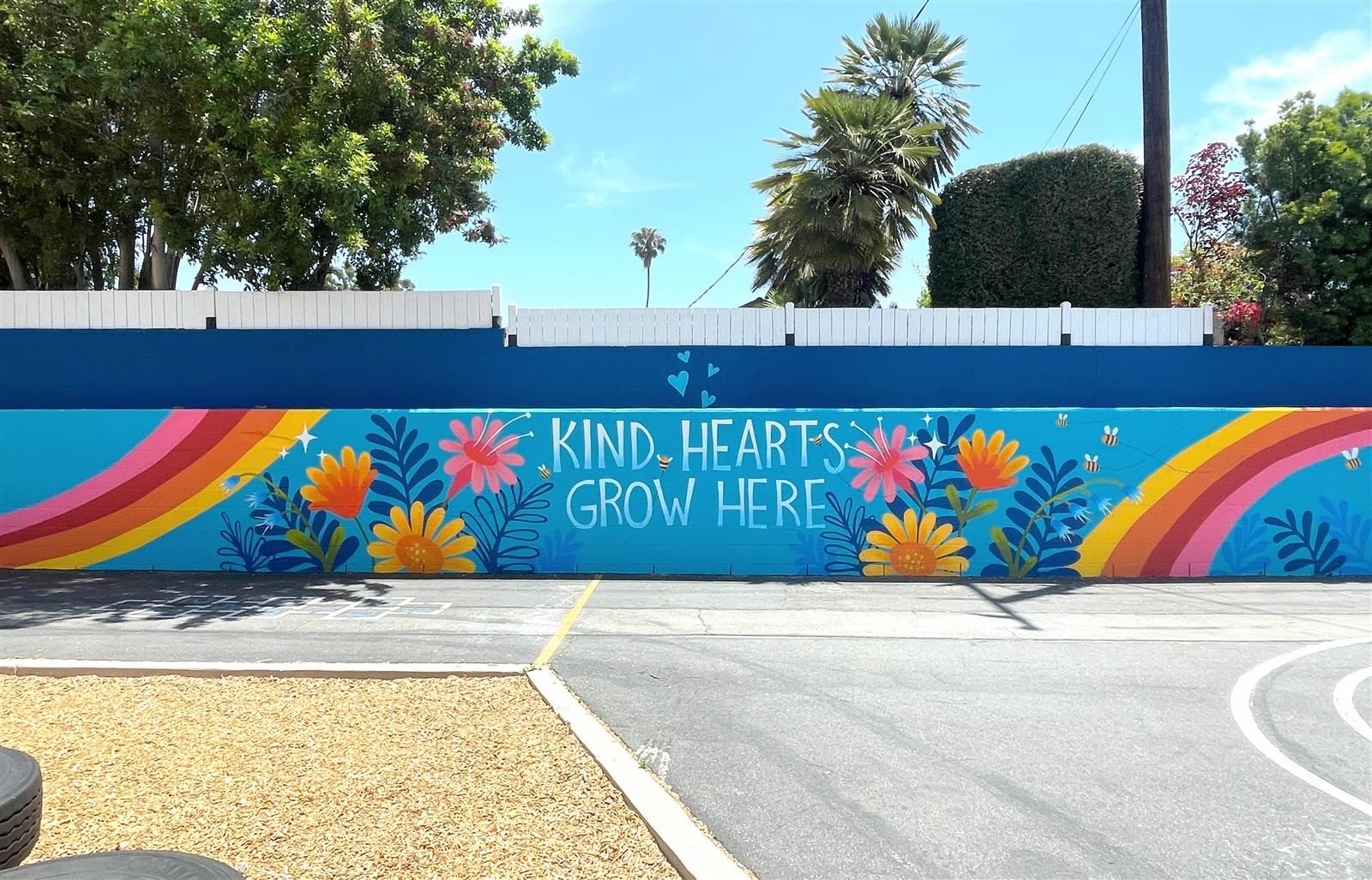kind Hearts Grow Here verbiage on a mural
